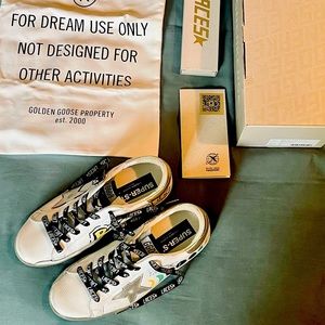 Golden Goose superstar classic sneakers with custom graffiti.